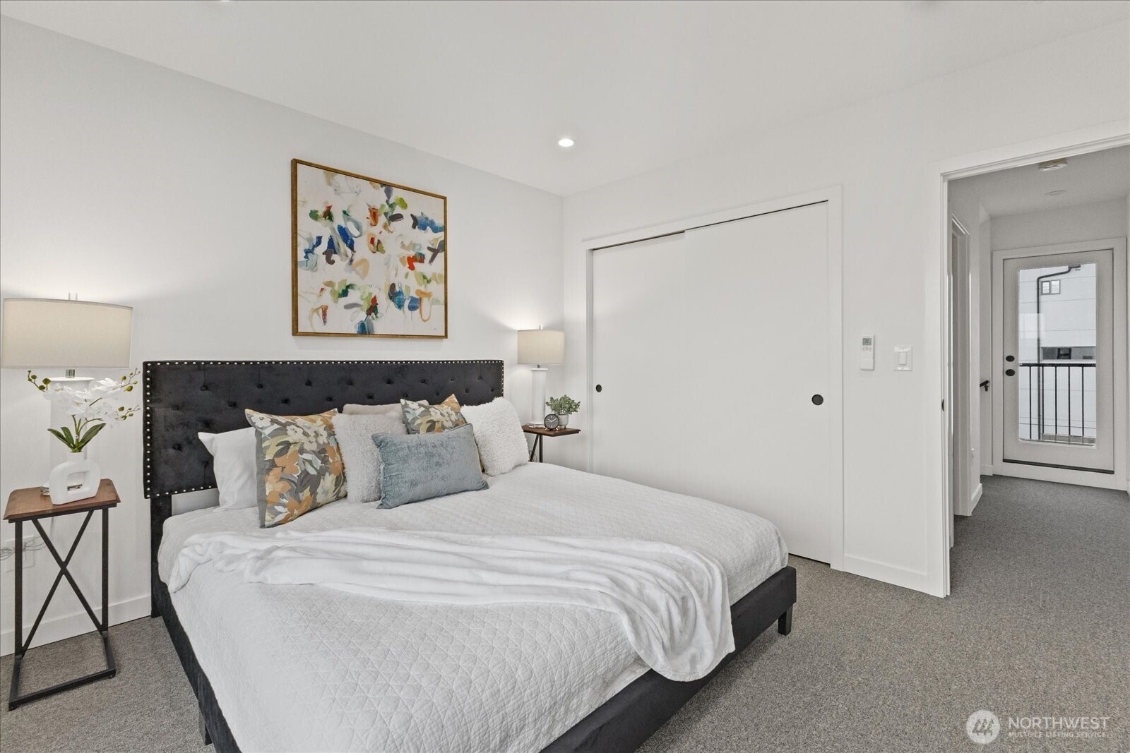 5439 California Avenue Southwest, Unit H Seattle, WA 98136 - Photo 18 of 23 a bedroom with a bed and painting on the wall