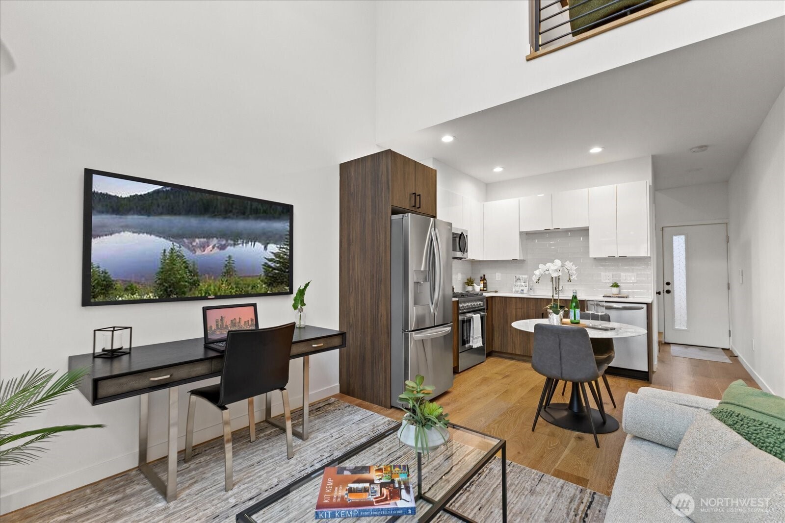 5439 California Avenue Southwest, Unit H Seattle, WA 98136 - Photo 5 of 23 a kitchen with stainless steel appliances kitchen island granite countertop a refrigerator and a stove top oven