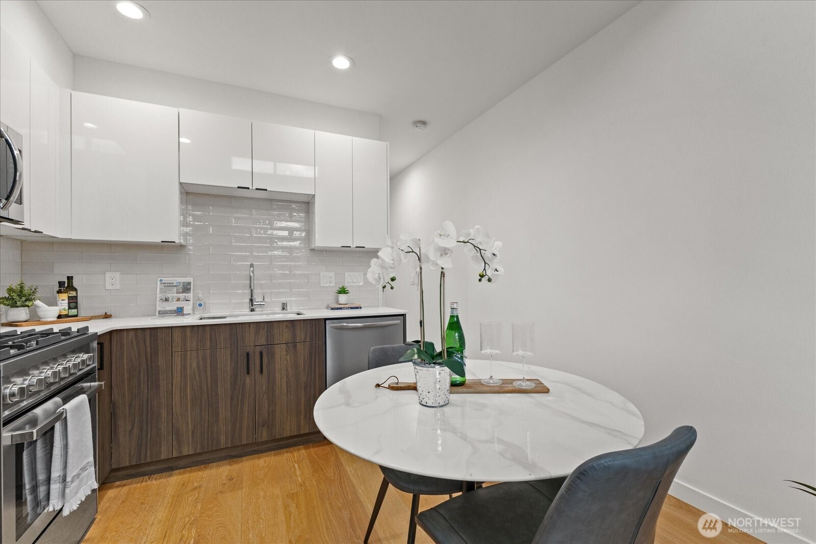 5439 California Avenue Southwest, Unit H Seattle, WA 98136 - Photo 8 of 23 a kitchen with stainless steel appliances a sink and cabinets