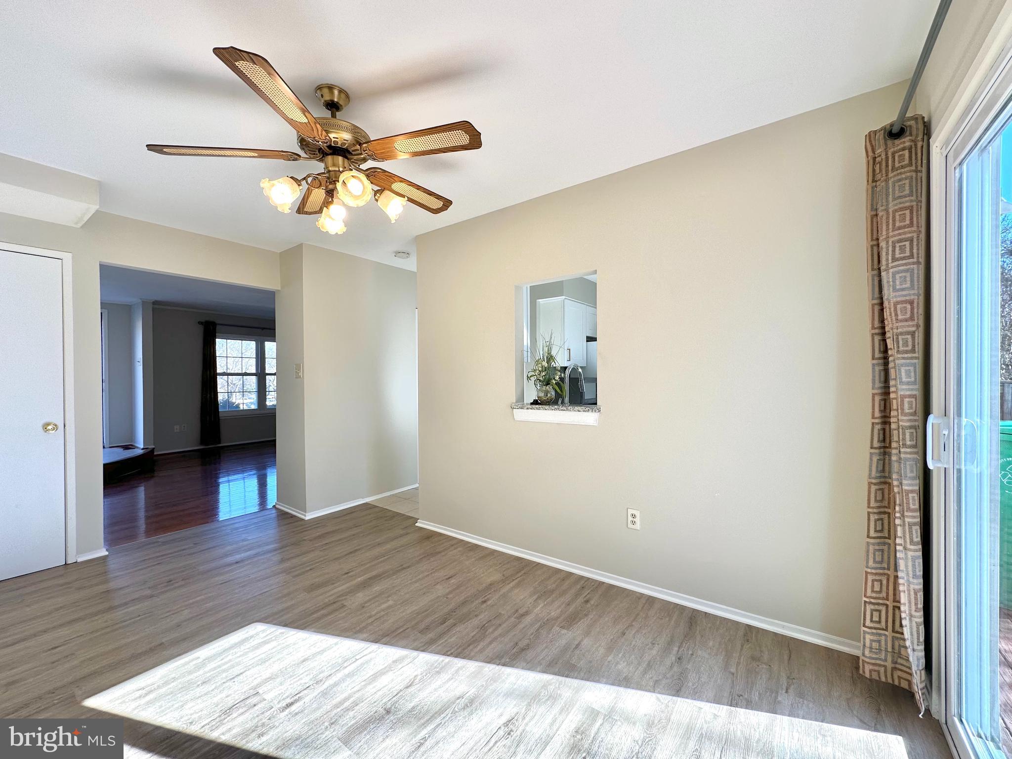 402 Carousel Court Gaithersburg, MD 20877 - Photo 12 of 29 a view of a livingroom with wooden floor and a ceiling fan