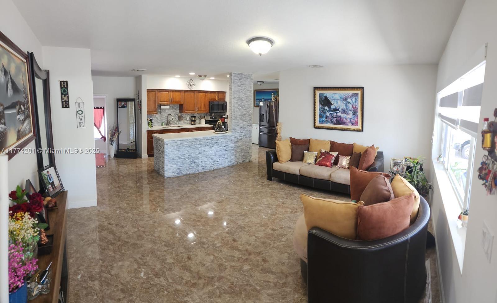 341 West 59th Street Hialeah, FL 33012 - Photo 11 of 44 a living room with furniture and a flat screen tv