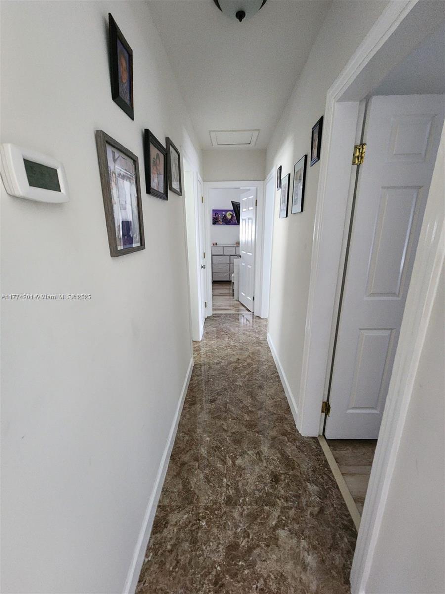 341 West 59th Street Hialeah, FL 33012 - Photo 14 of 44 a view of a hallway with wooden floor and entryway