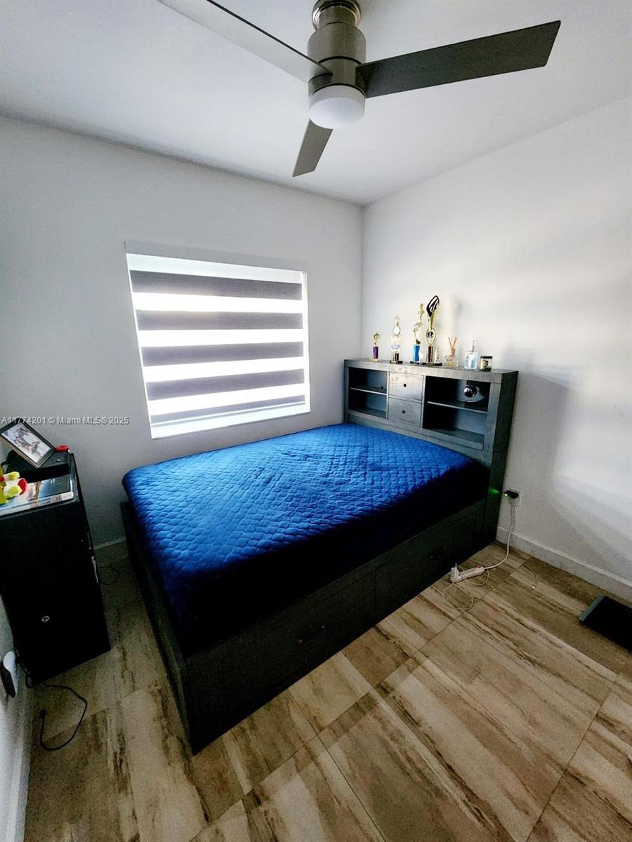 341 West 59th Street Hialeah, FL 33012 - Photo 16 of 44 a bed sitting in a bedroom next to a window