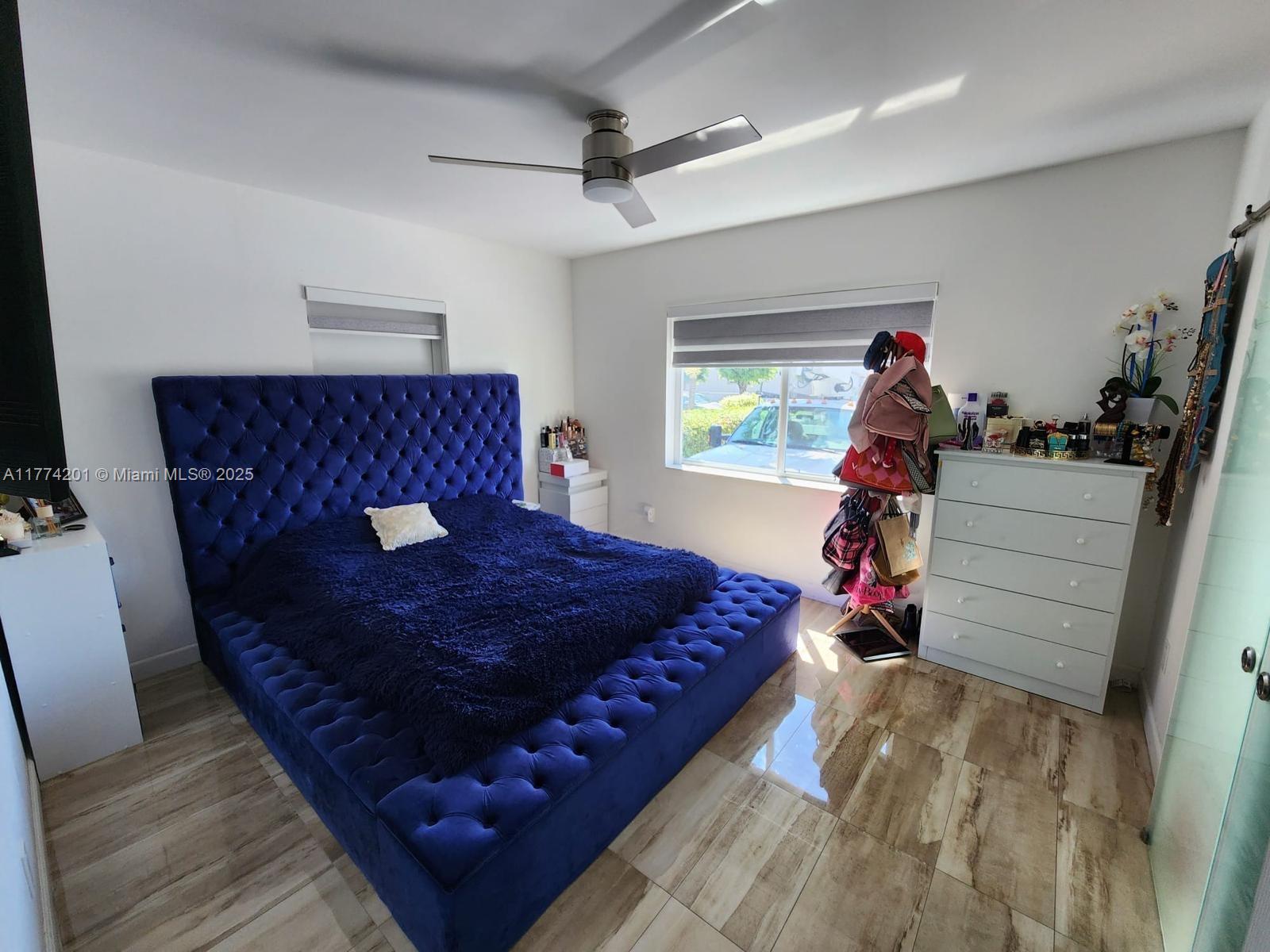 341 West 59th Street Hialeah, FL 33012 - Photo 19 of 44 a bed sitting in a bedroom next to a window