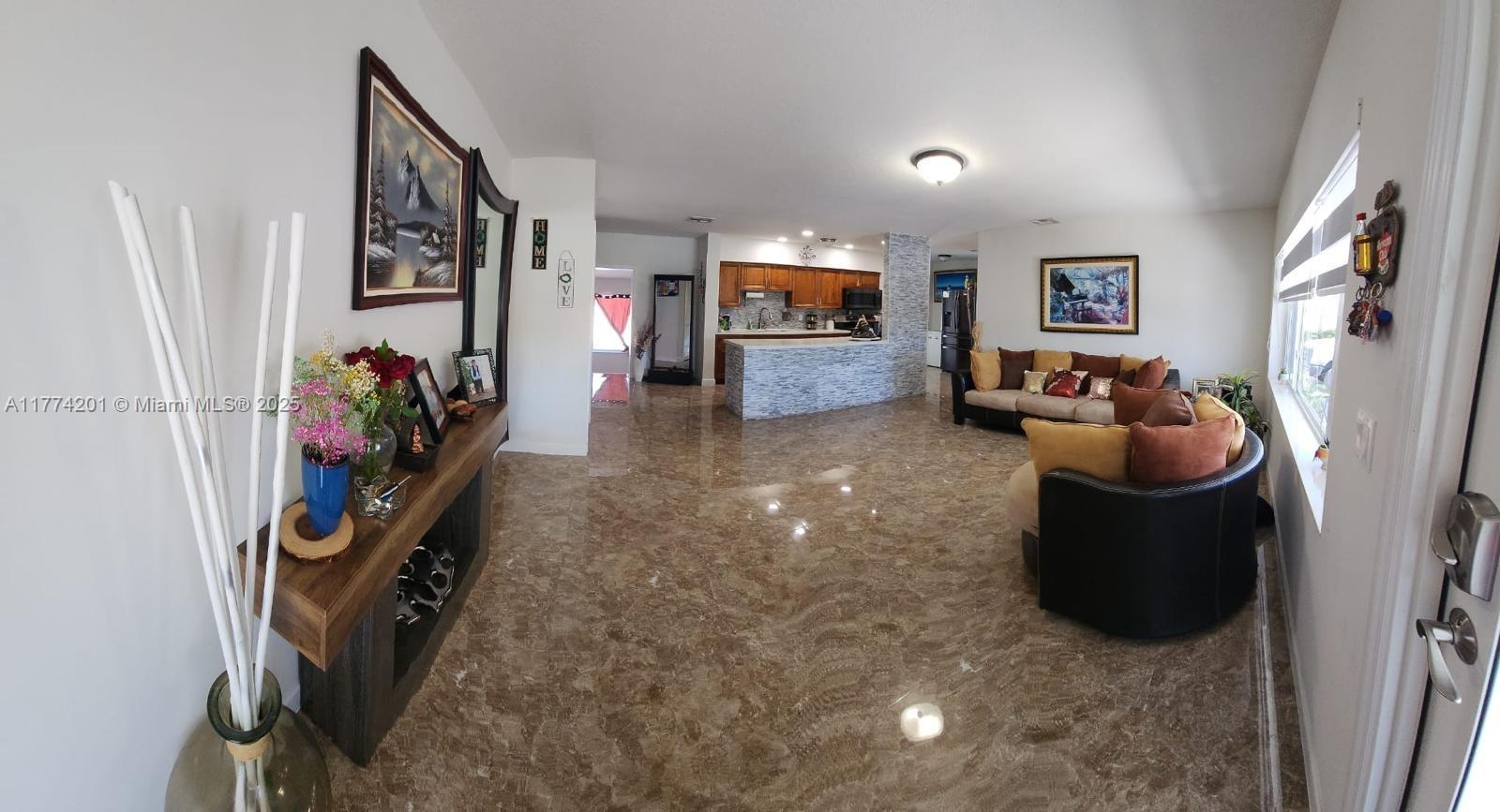 341 West 59th Street Hialeah, FL 33012 - Photo 20 of 44 a living room with furniture and a flat screen tv