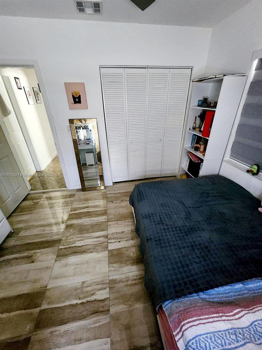 341 West 59th Street Hialeah, FL 33012 - Photo 21 of 44 a living room with a couch and a walk in closet