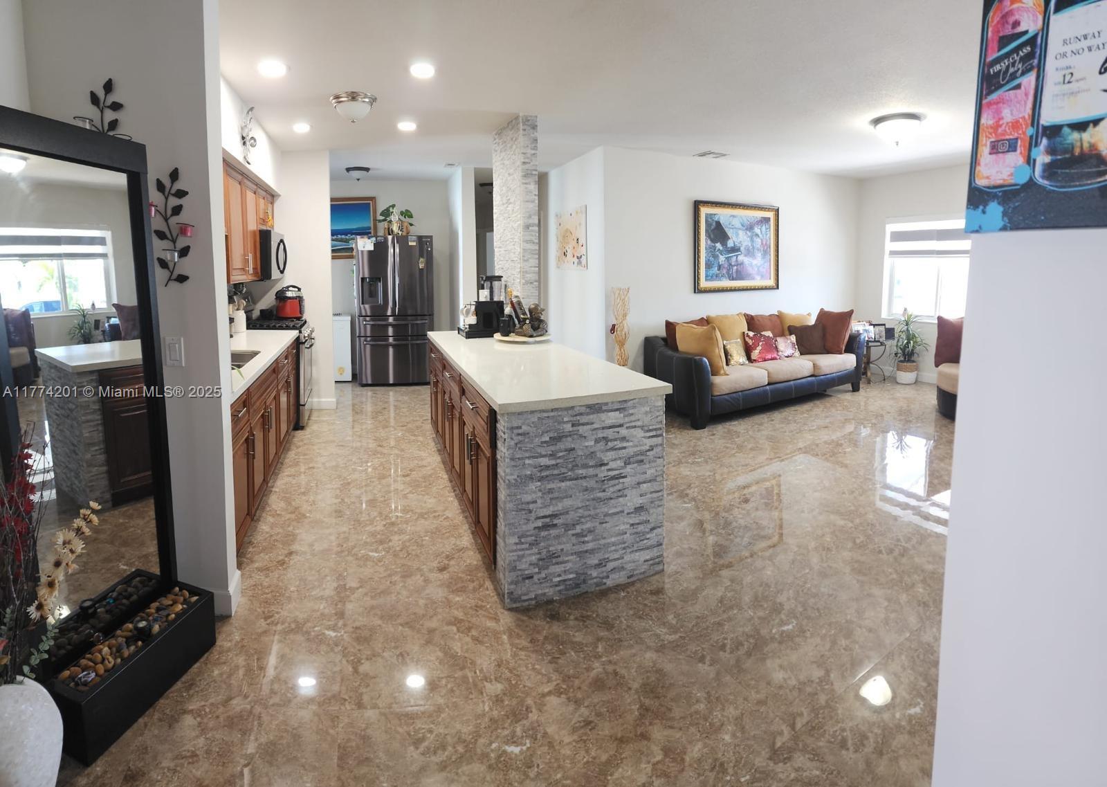 341 West 59th Street Hialeah, FL 33012 - Photo 22 of 44 a living room with furniture and a flat screen tv