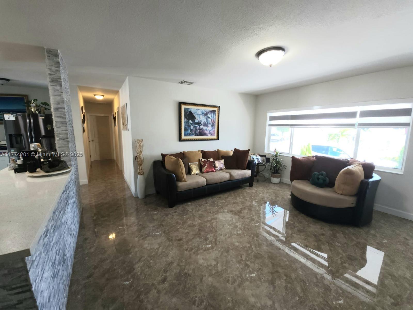 341 West 59th Street Hialeah, FL 33012 - Photo 23 of 44 a living room with furniture and a large window