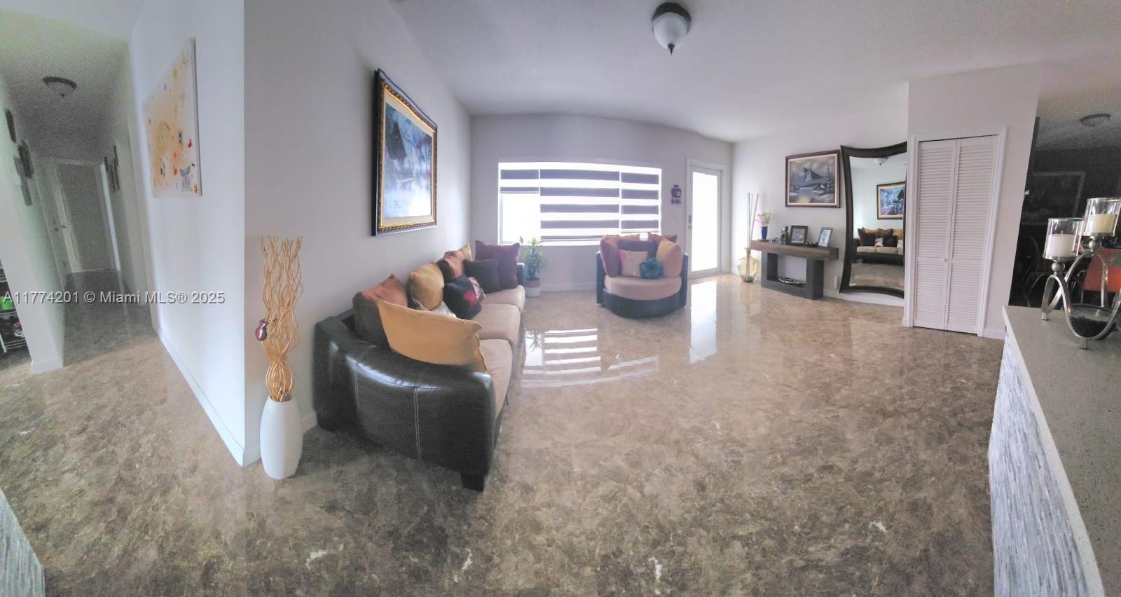 341 West 59th Street Hialeah, FL 33012 - Photo 26 of 44 a living room with furniture and a flat screen tv