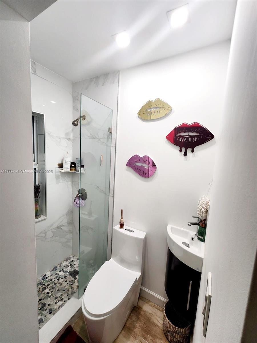 341 West 59th Street Hialeah, FL 33012 - Photo 28 of 44 a bathroom with a sink a toilet and a shower