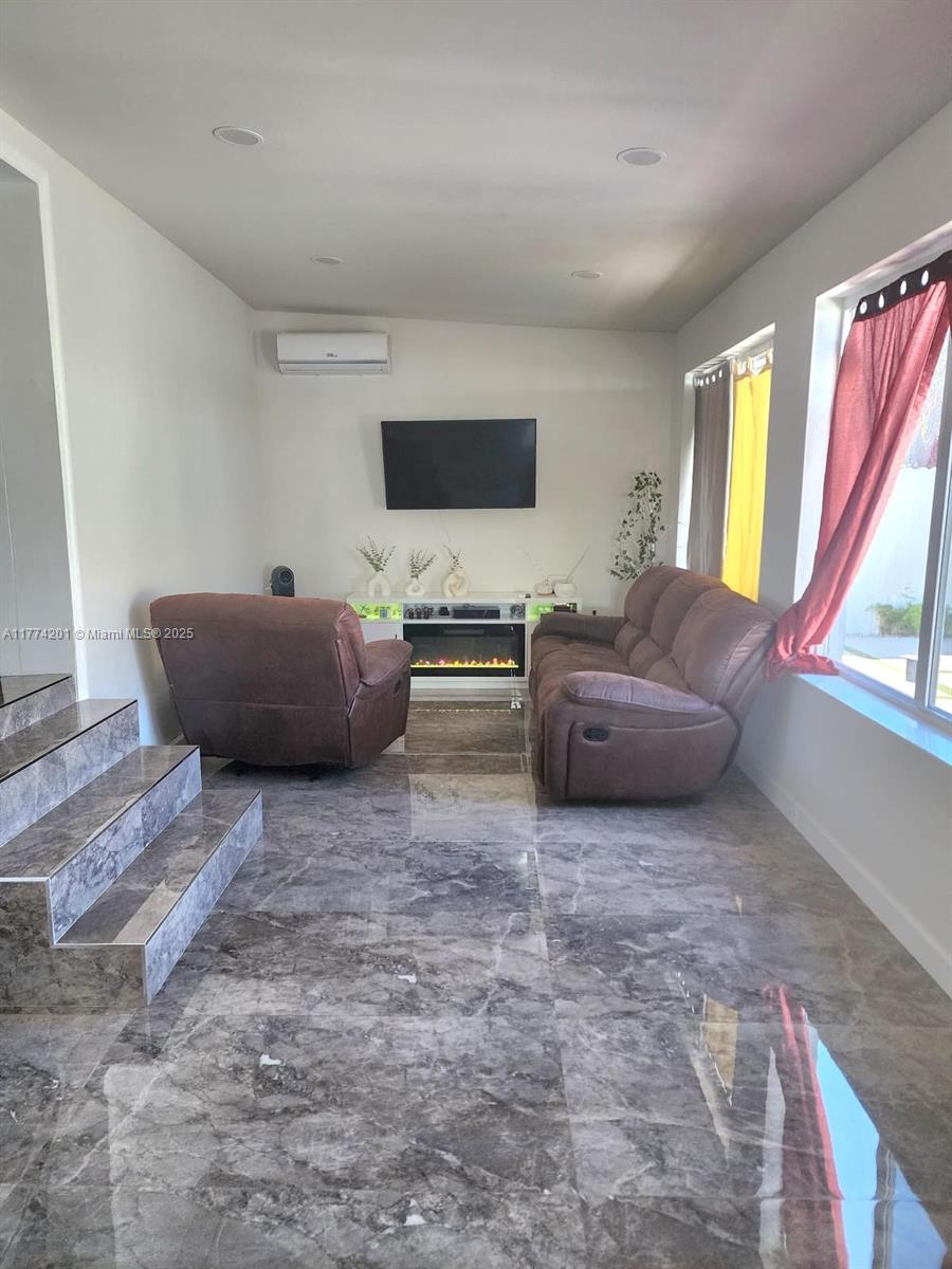 341 West 59th Street Hialeah, FL 33012 - Photo 29 of 44 a living room with furniture and a flat screen tv