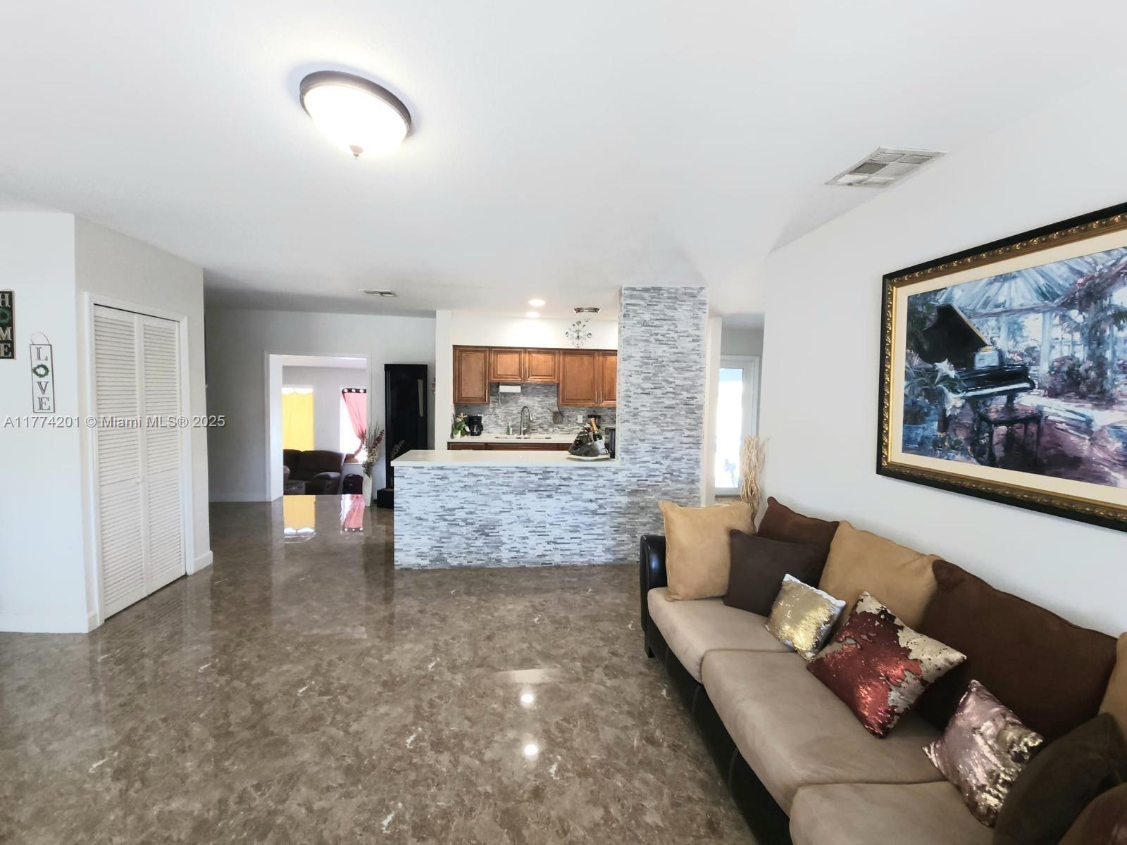 341 West 59th Street Hialeah, FL 33012 - Photo 30 of 44 a living room with furniture and a flat screen tv