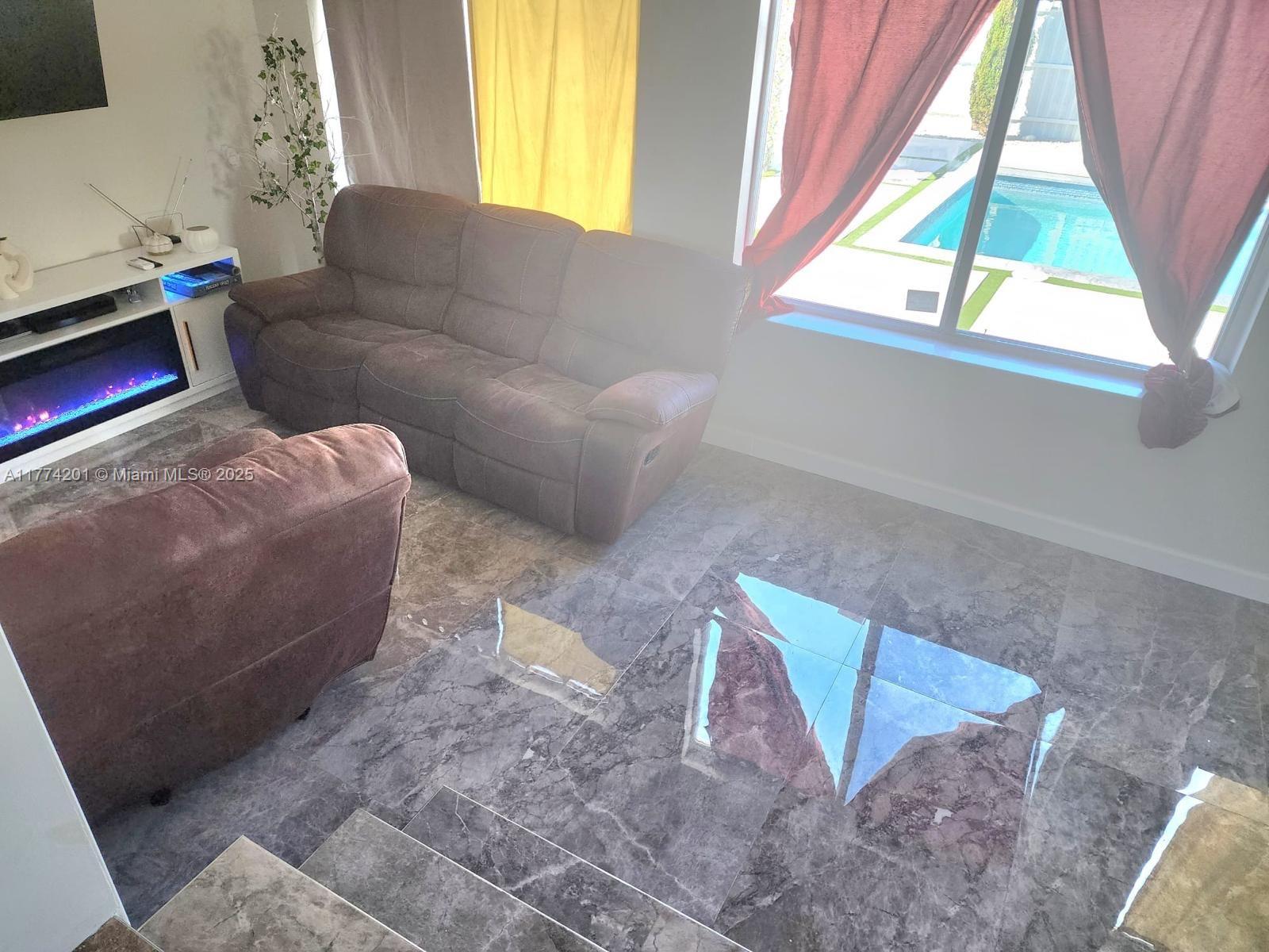 341 West 59th Street Hialeah, FL 33012 - Photo 31 of 44 a living room with furniture and a window