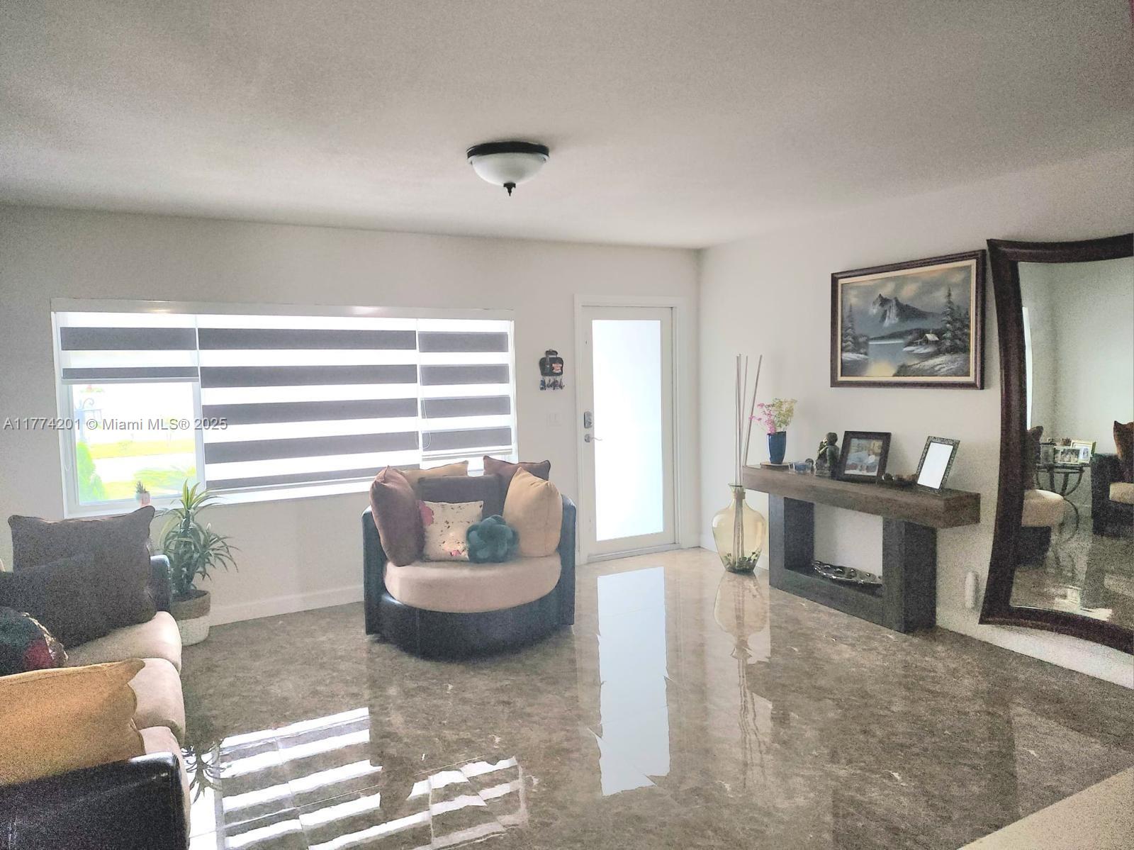 341 West 59th Street Hialeah, FL 33012 - Photo 33 of 44 a living room with furniture and a window