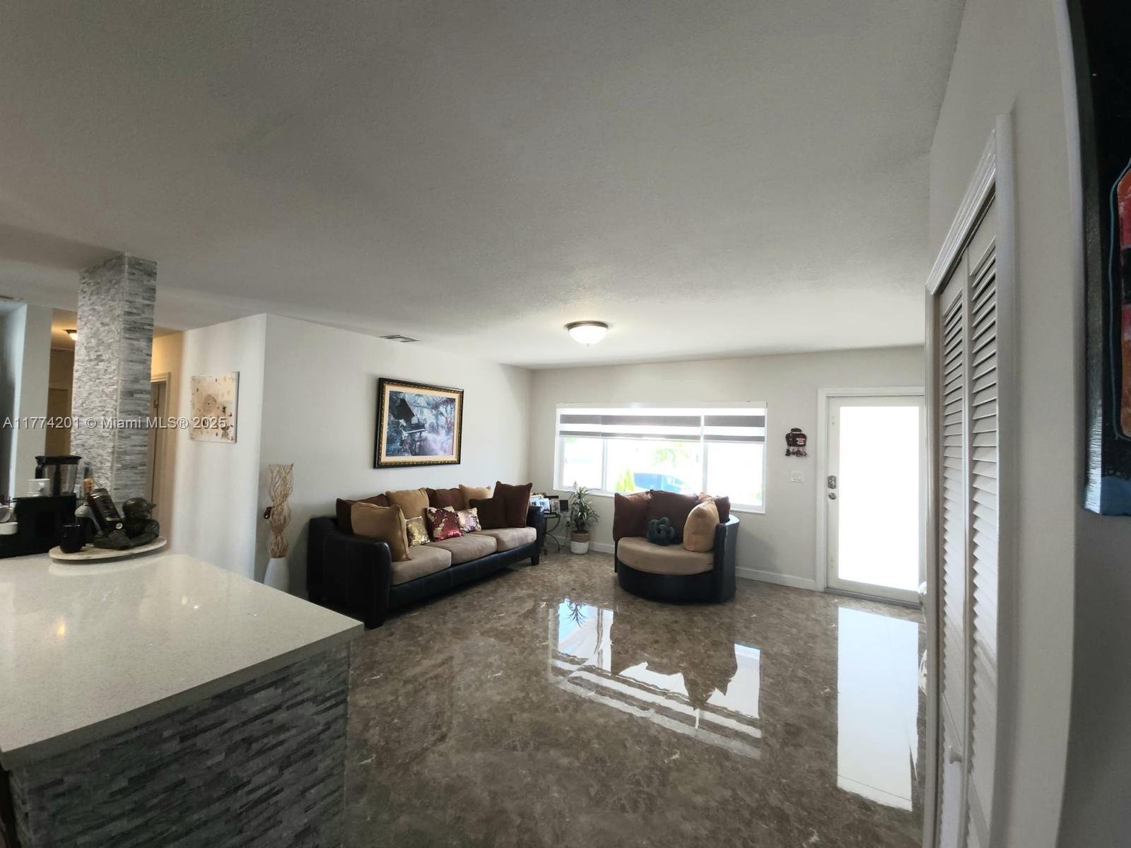 341 West 59th Street Hialeah, FL 33012 - Photo 37 of 44 a bedroom with furniture and a flat screen tv