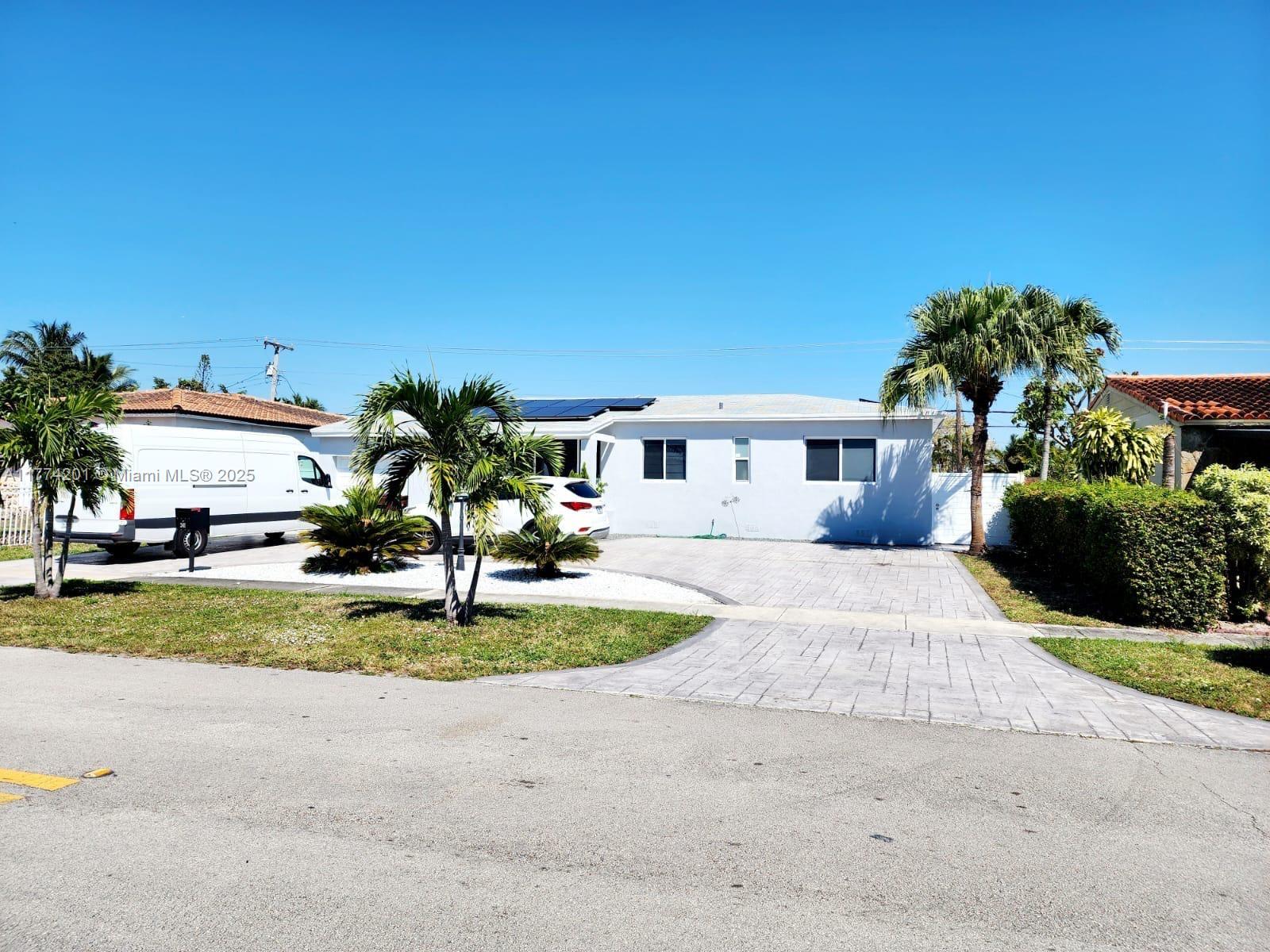 341 West 59th Street Hialeah, FL 33012 - Photo 4 of 44 a front view of a house with a garden and porch