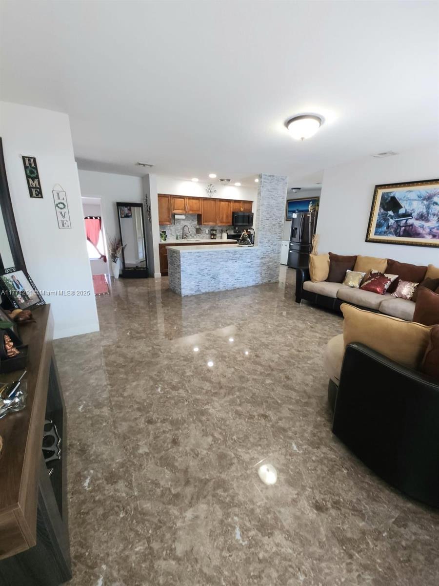 341 West 59th Street Hialeah, FL 33012 - Photo 6 of 44 a living room with furniture and a flat screen tv