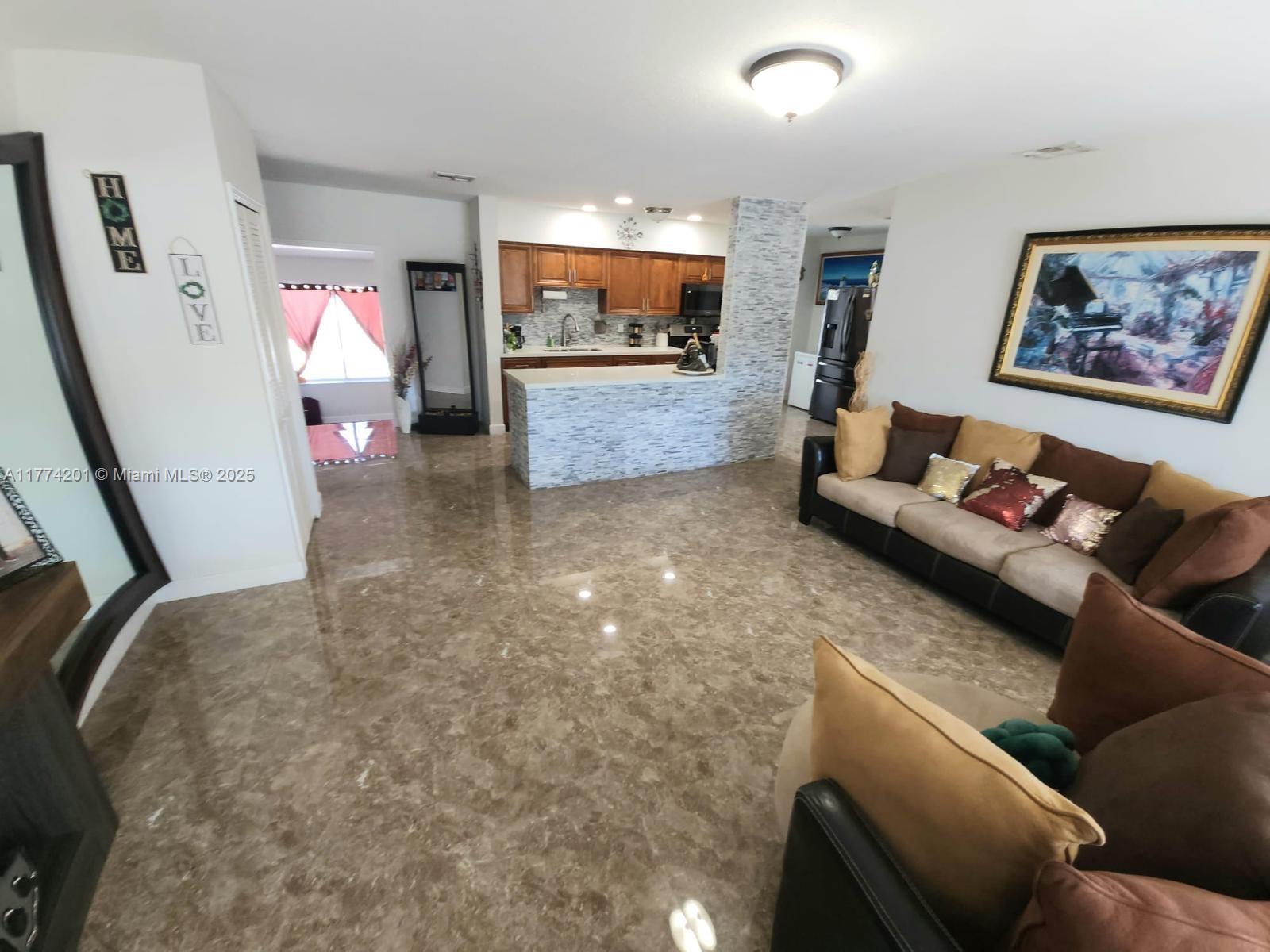 341 West 59th Street Hialeah, FL 33012 - Photo 7 of 44 a living room with furniture and a flat screen tv