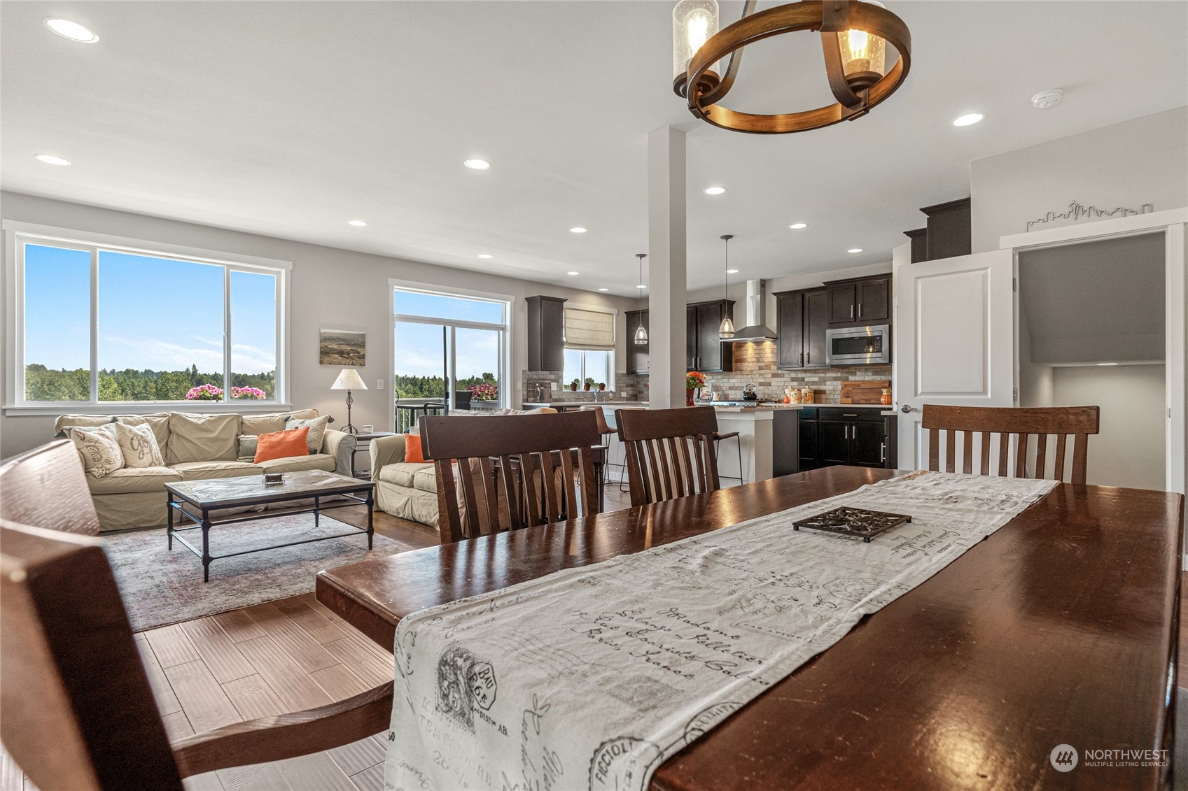 19012 123rd Avenue Southeast Renton, WA 98058 - Photo 11 of 40 a living room with kitchen island furniture and a wooden floor
