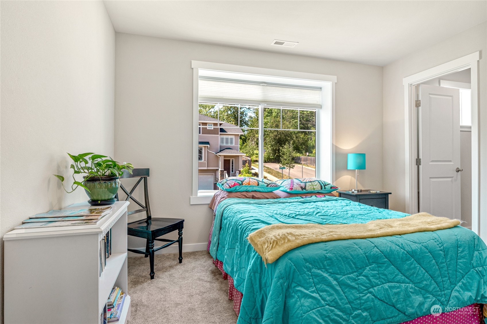 19012 123rd Avenue Southeast Renton, WA 98058 - Photo 28 of 40 a bed sitting in a bedroom next to a window