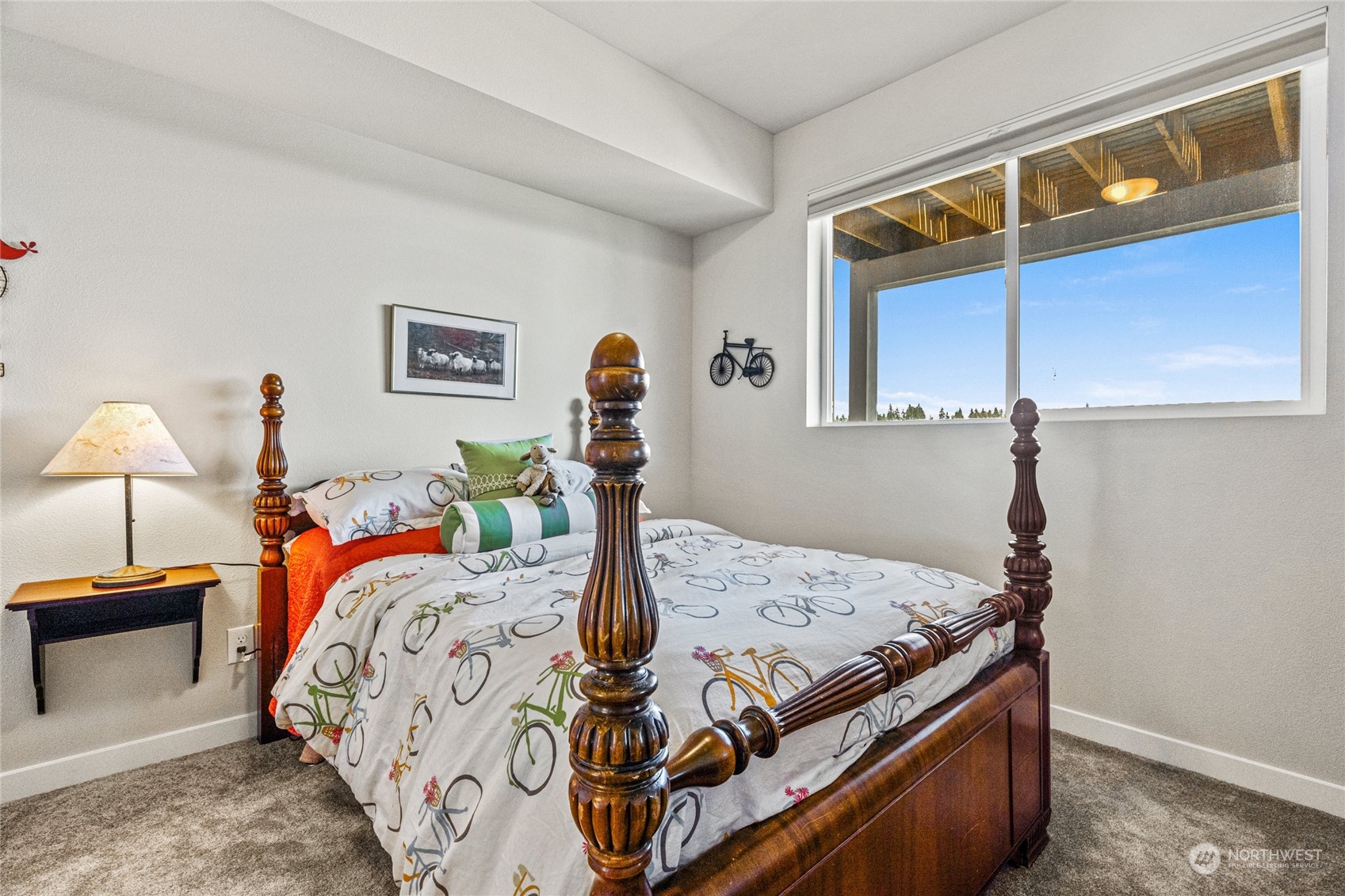 19012 123rd Avenue Southeast Renton, WA 98058 - Photo 32 of 40 a bed sitting in a bedroom next to a window