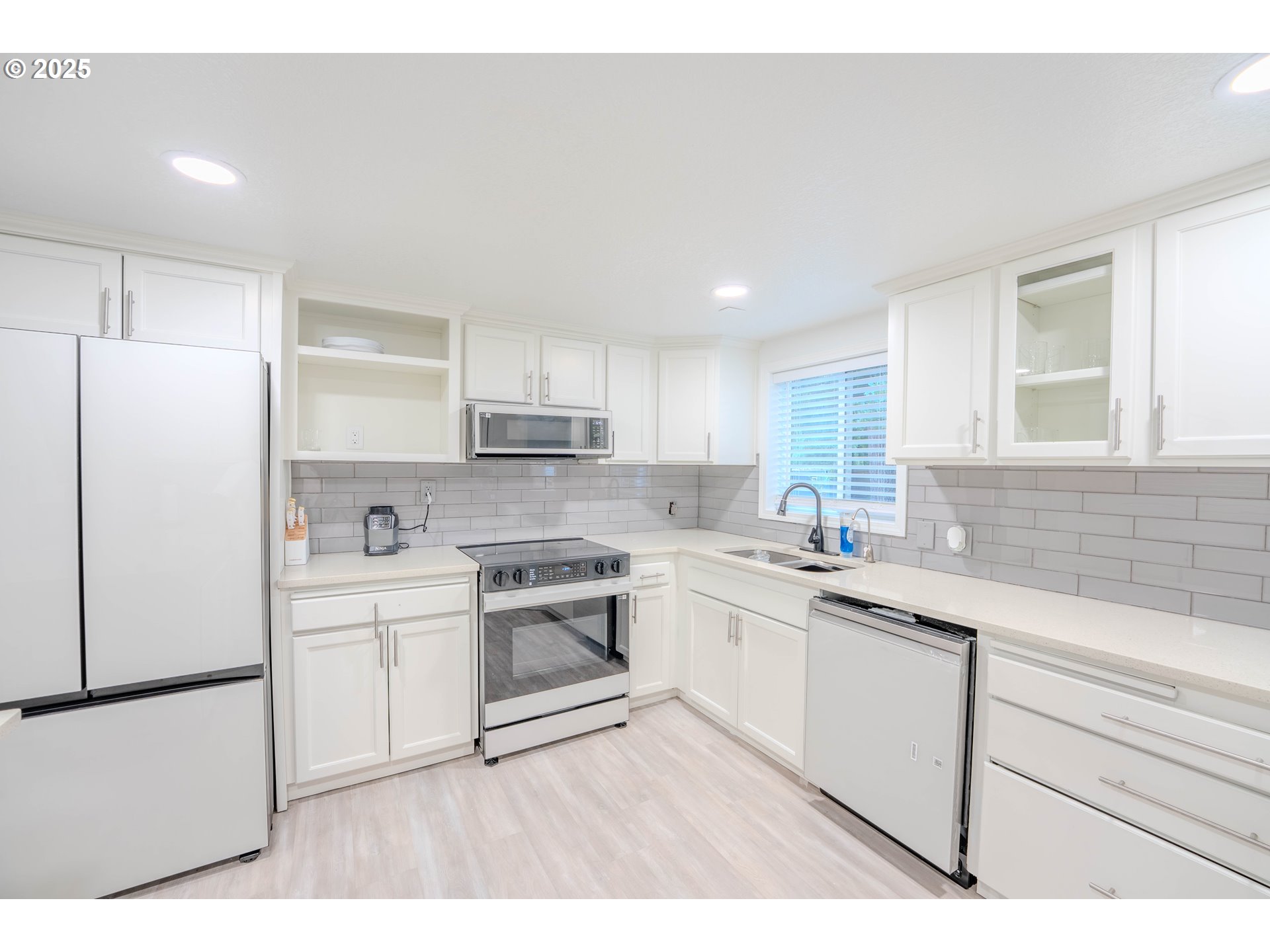 15550 Southeast Tickle Creek Road Boring, OR 97009 - Photo 11 of 13 a kitchen with a sink a white cabinets and stainless steel appliances