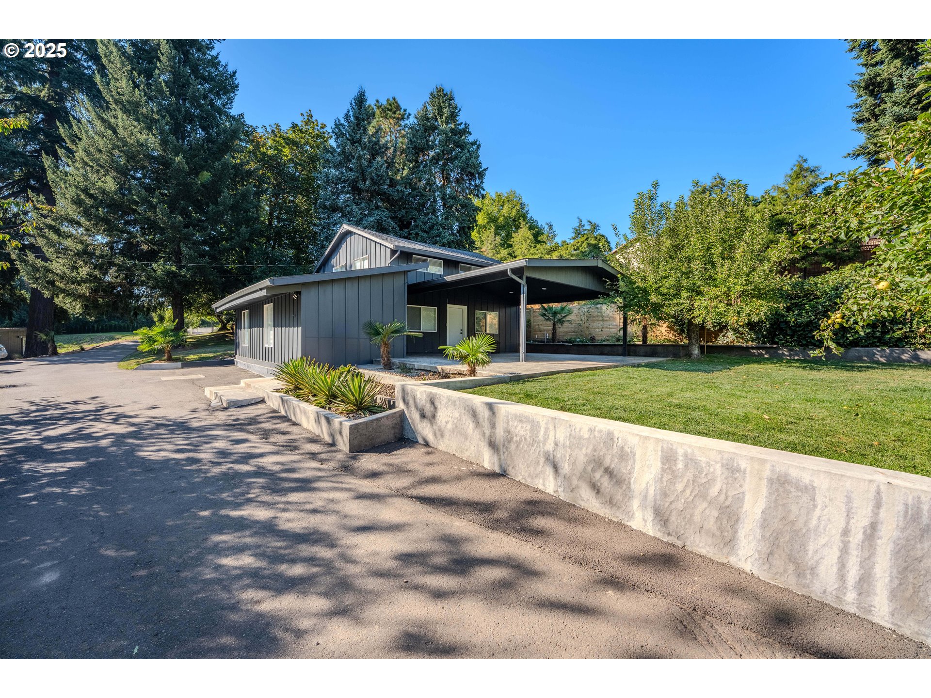 15550 Southeast Tickle Creek Road Boring, OR 97009 - Photo 3 of 13 a view of a house with a yard patio and fire pit