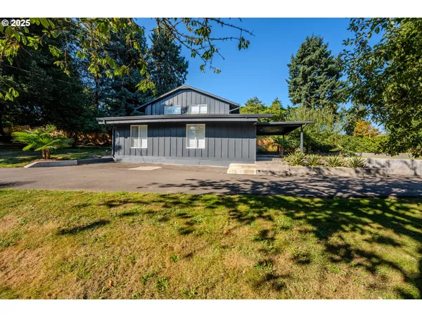 a view of empty room with wooden floor and sink