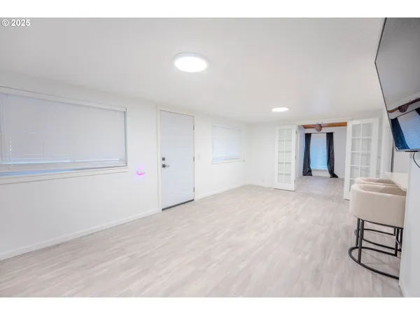 a kitchen with a sink a white cabinets and stainless steel appliances