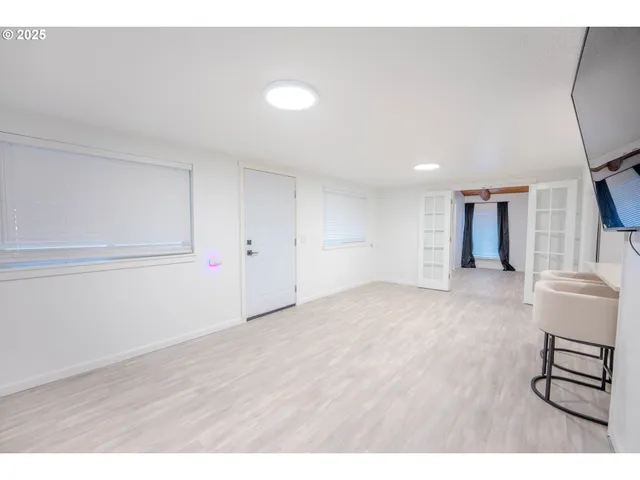 a kitchen with a sink a white cabinets and stainless steel appliances
