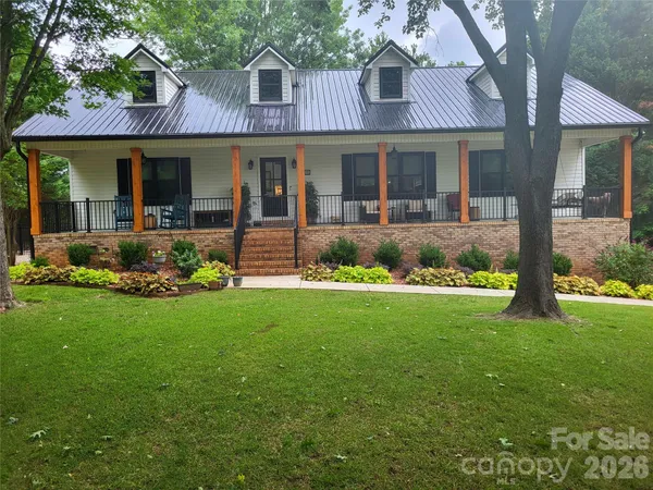 a front view of a house with garden and porch
