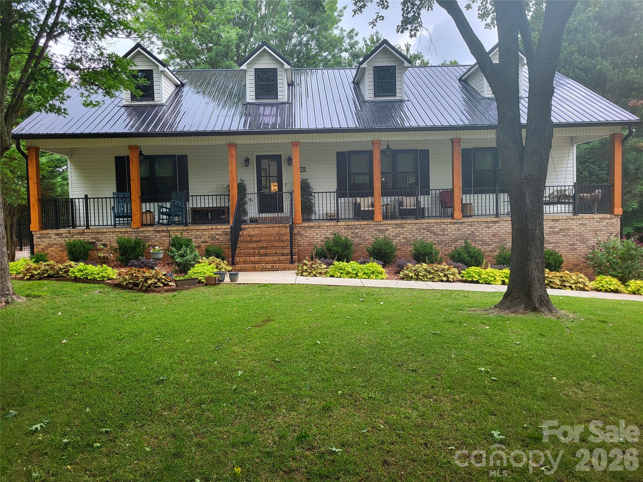 2549 Lake Shore Road South Denver, NC 28037 - Photo 1 of 47 a front view of a house with garden and porch