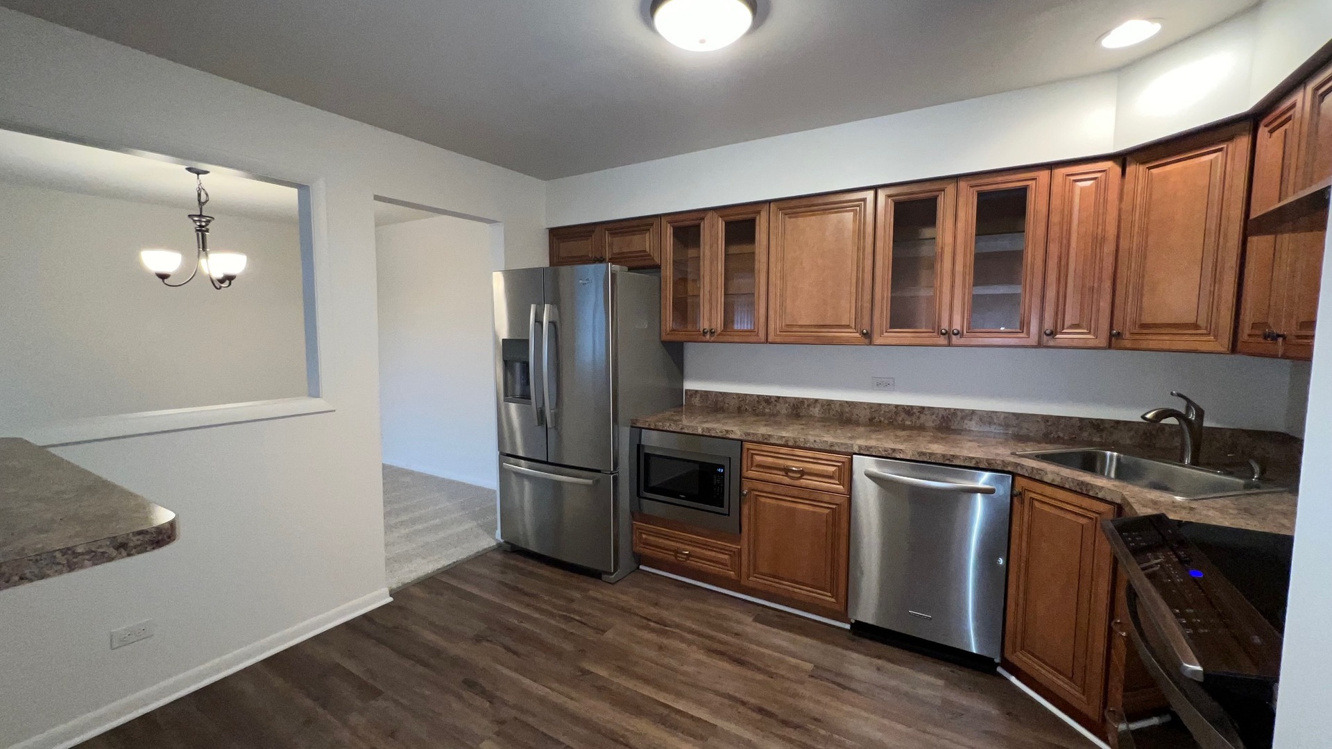 850 South Lorraine Road, Unit 3L Wheaton, IL 60189 - Photo 8 of 21 a kitchen with stainless steel appliances granite countertop a refrigerator a stove a sink and a microwave