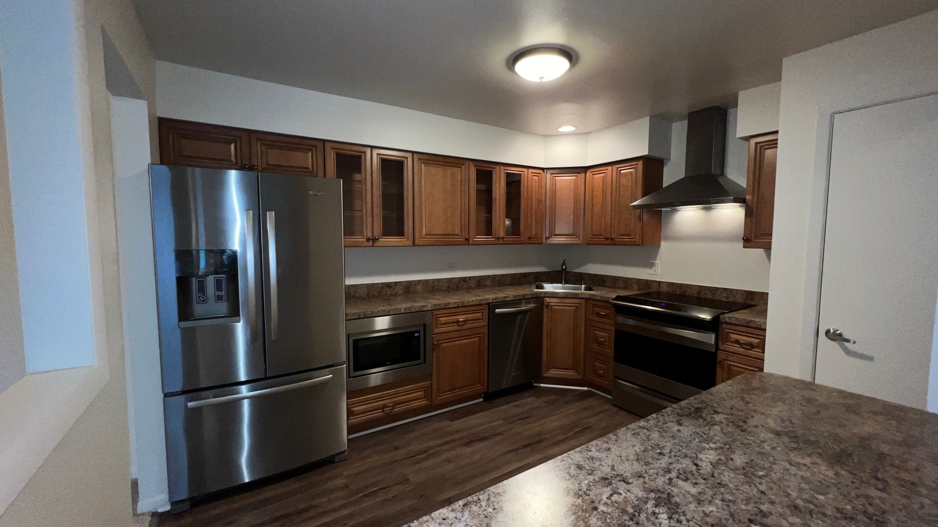 850 South Lorraine Road, Unit 3L Wheaton, IL 60189 - Photo 10 of 21 a kitchen with granite countertop stainless steel appliances and wooden cabinets