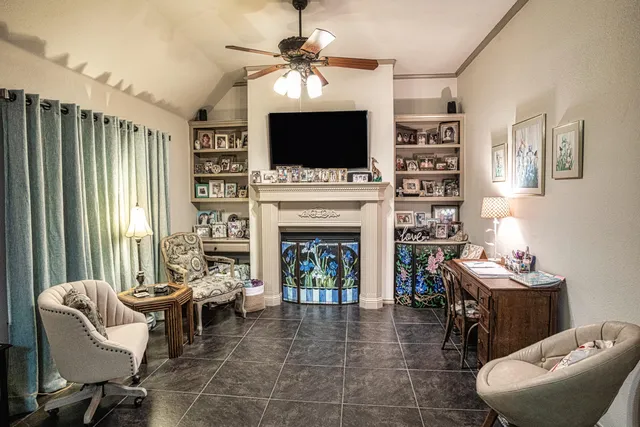 an empty room with potted plants and wooden floor
