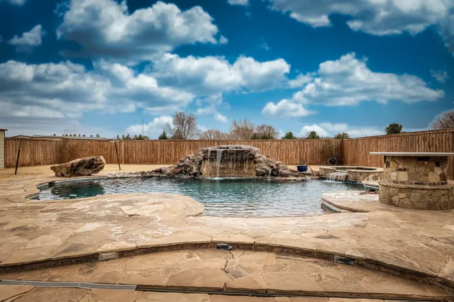 a front view of house with yard and car parked