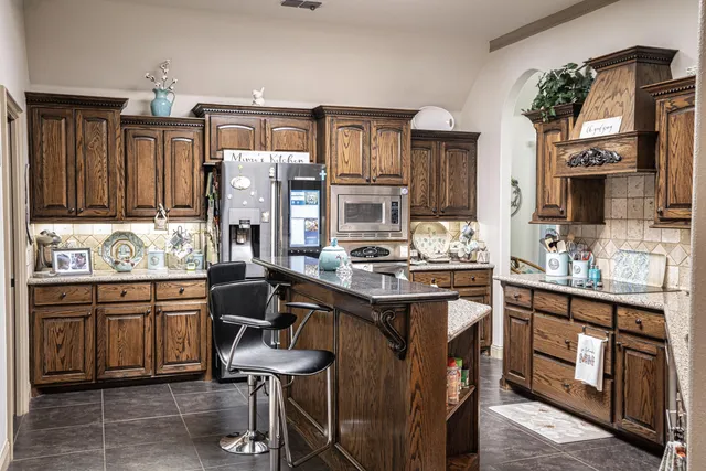 a kitchen with sink and view of living room