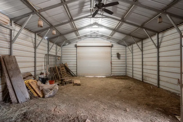 a view of backyard with wooden fence