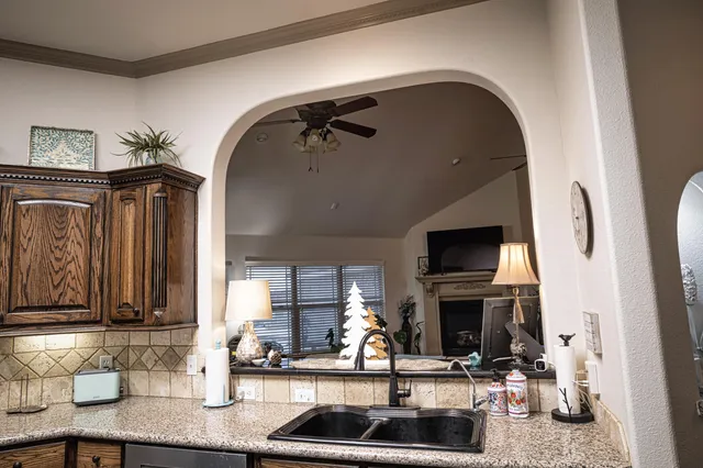 a living room with furniture chandelier and a window