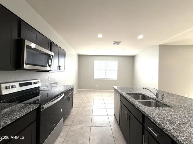 a kitchen with a sink stove and microwave