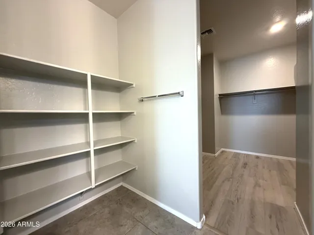 a view of an empty room with a closet