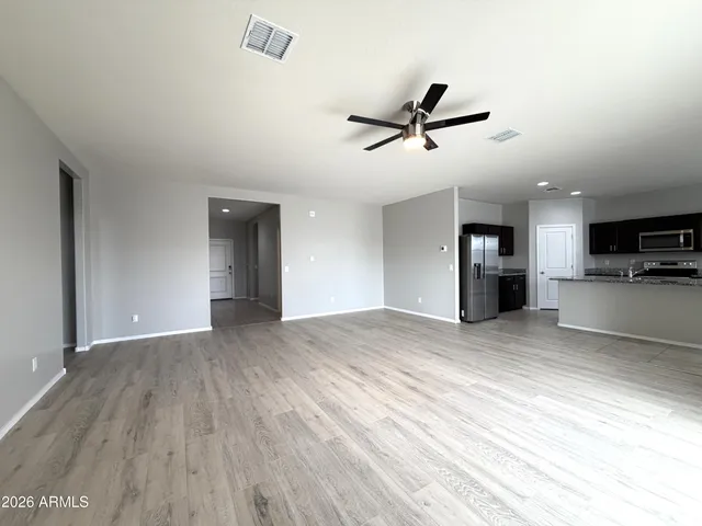 a view of a kitchen with a sink and a refrigerator
