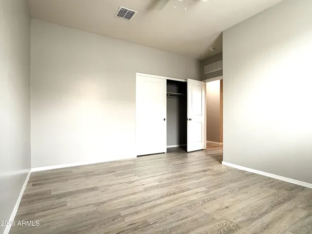 a view of an empty room with wooden floor