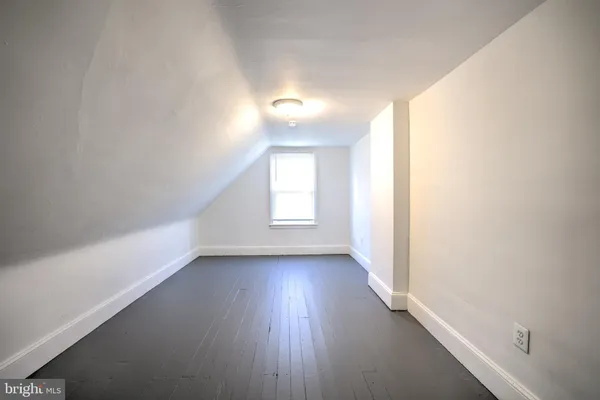 a view of a room with wooden floor and window