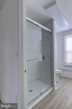 a bathroom with a glass shower door