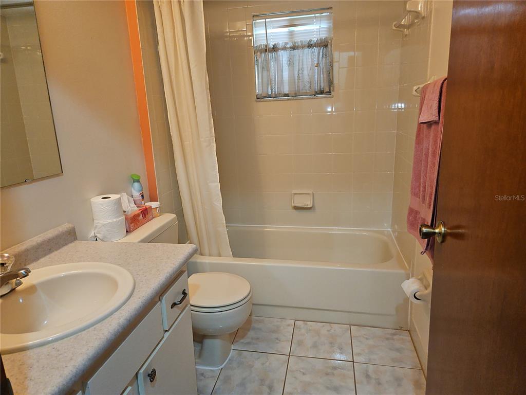 11087 Southwest 77th Court Ocala, FL 34476 - Photo 16 of 31 a bathroom with a sink toilet and shower