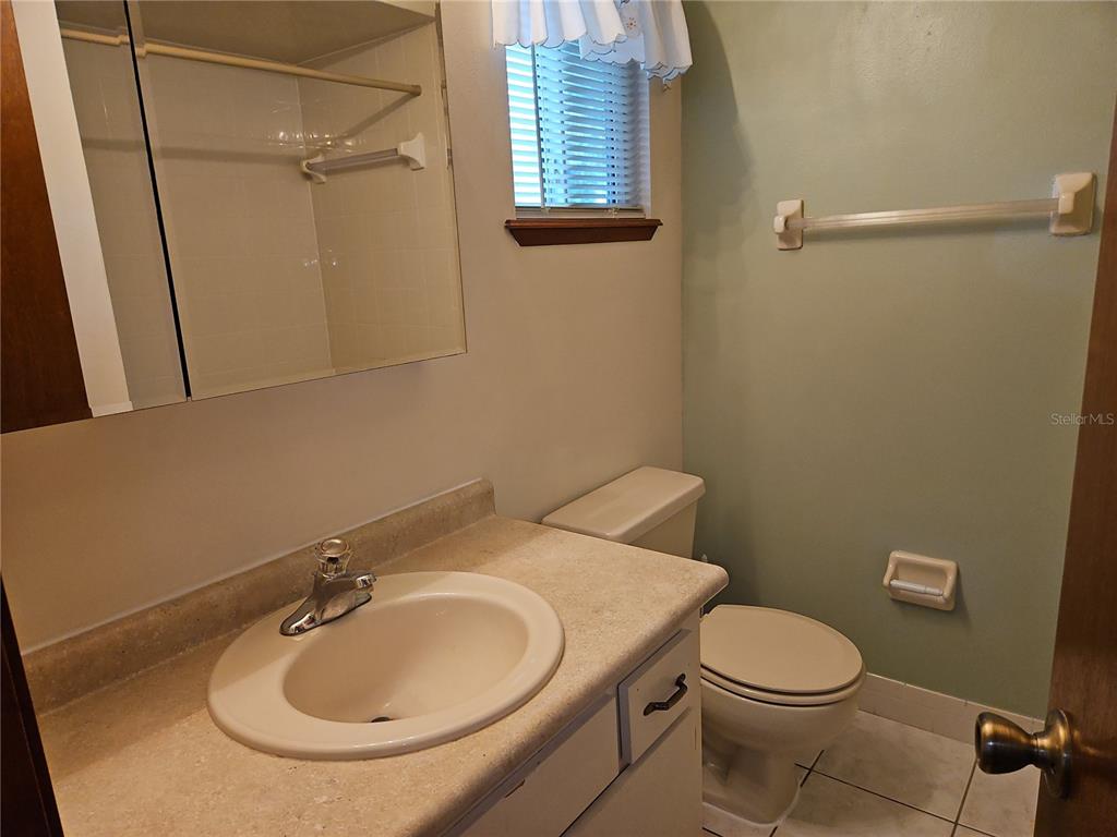 11087 Southwest 77th Court Ocala, FL 34476 - Photo 19 of 31 a bathroom with a sink a toilet and shower