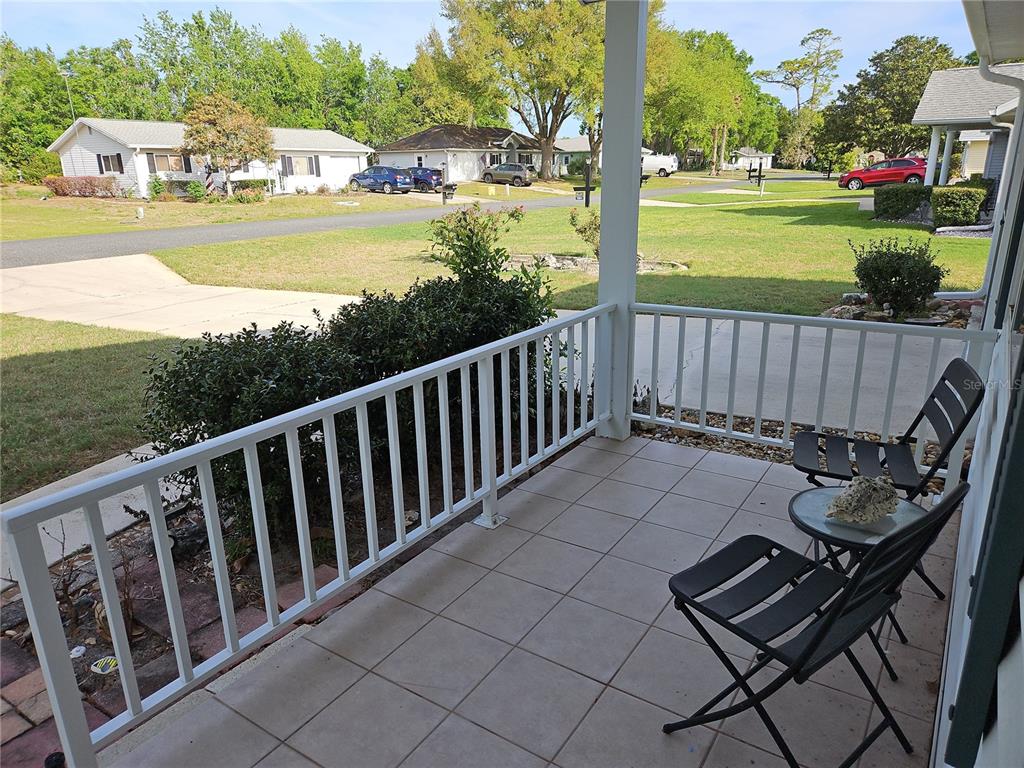 11087 Southwest 77th Court Ocala, FL 34476 - Photo 2 of 31 a view of a chair and tables on the terrace