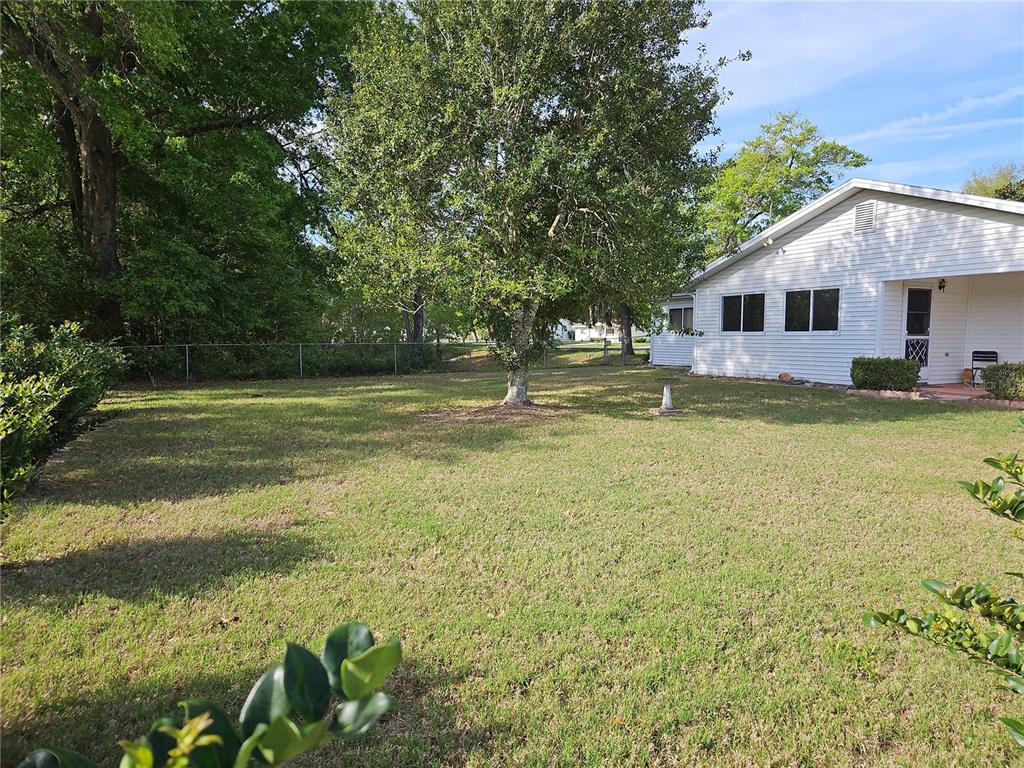11087 Southwest 77th Court Ocala, FL 34476 - Photo 24 of 31 a view of a house with a yard