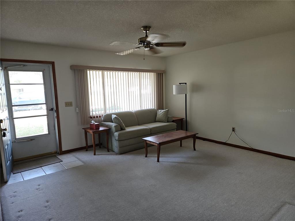 11087 Southwest 77th Court Ocala, FL 34476 - Photo 4 of 31 a living room with furniture and a ceiling fan
